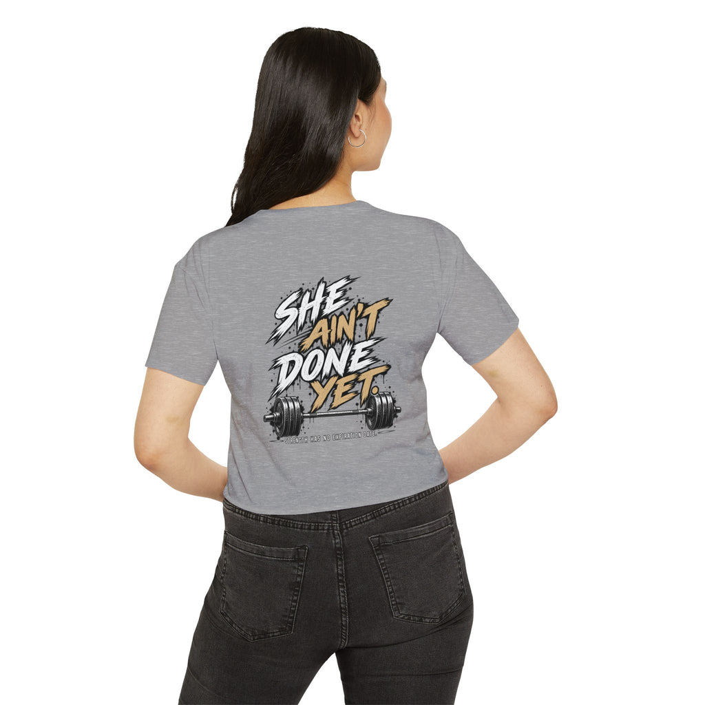 Women's Cropped Tee — "She Ain't Done Yet" Fitness Graphic